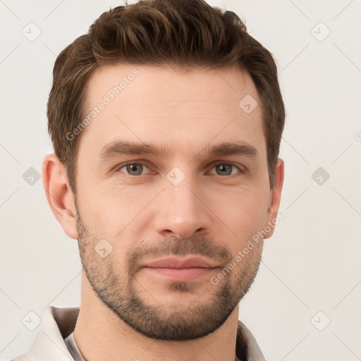 Joyful white young-adult male with short  brown hair and grey eyes