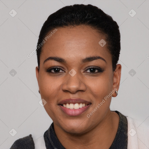 Joyful black young-adult female with short  black hair and brown eyes