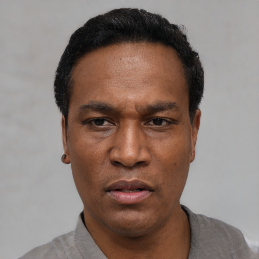 Neutral latino adult male with short  black hair and brown eyes