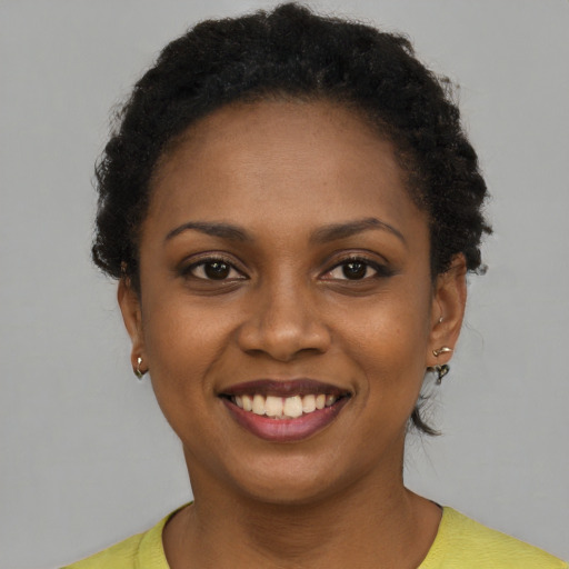 Joyful latino young-adult female with short  brown hair and brown eyes