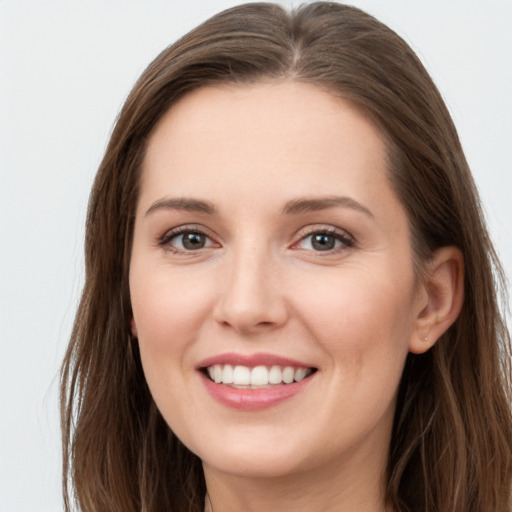 Joyful white young-adult female with long  brown hair and grey eyes