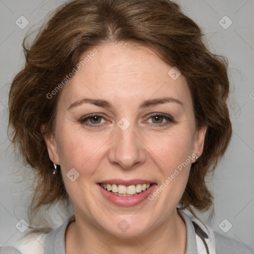 Joyful white adult female with medium  brown hair and blue eyes