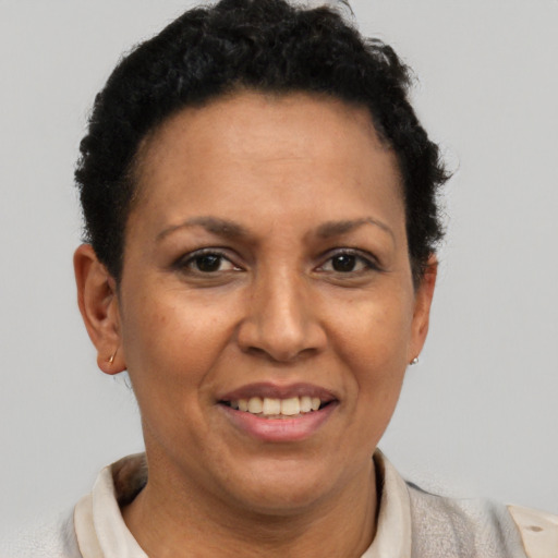 Joyful latino adult female with short  brown hair and brown eyes