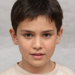 Joyful white child male with short  brown hair and brown eyes