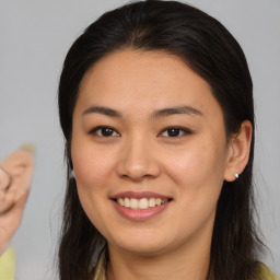 Joyful latino young-adult female with medium  brown hair and brown eyes