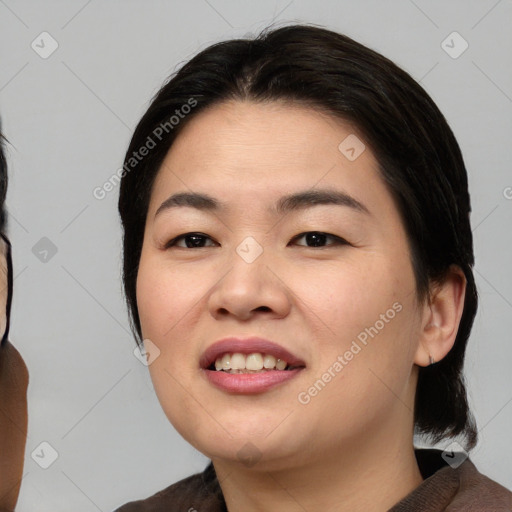 Joyful asian young-adult female with medium  black hair and brown eyes