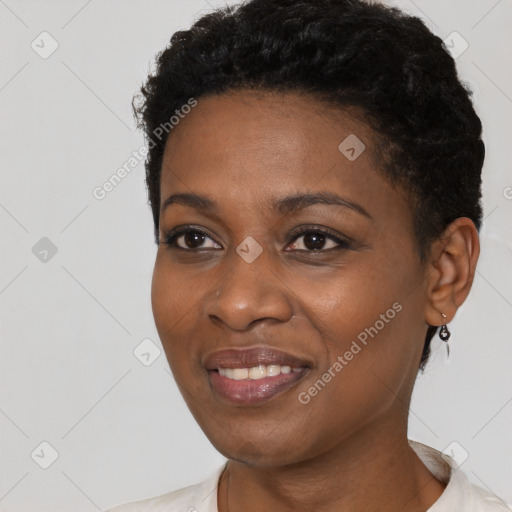 Joyful black young-adult female with short  black hair and brown eyes