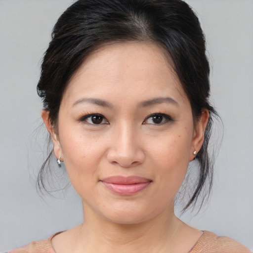 Joyful asian young-adult female with medium  brown hair and brown eyes