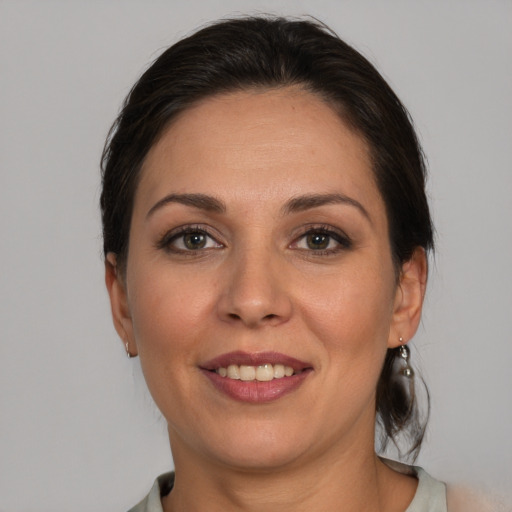 Joyful white adult female with medium  brown hair and brown eyes