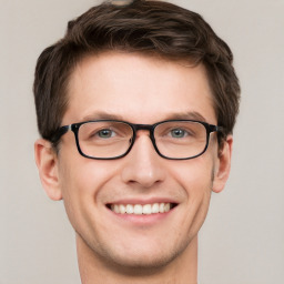 Joyful white adult male with short  brown hair and grey eyes