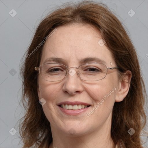 Joyful white adult female with long  brown hair and grey eyes