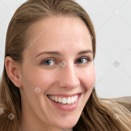 Joyful white young-adult female with long  brown hair and blue eyes