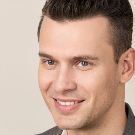 Joyful white young-adult male with short  brown hair and brown eyes