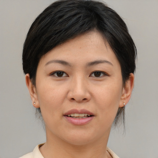 Joyful asian young-adult female with medium  brown hair and brown eyes