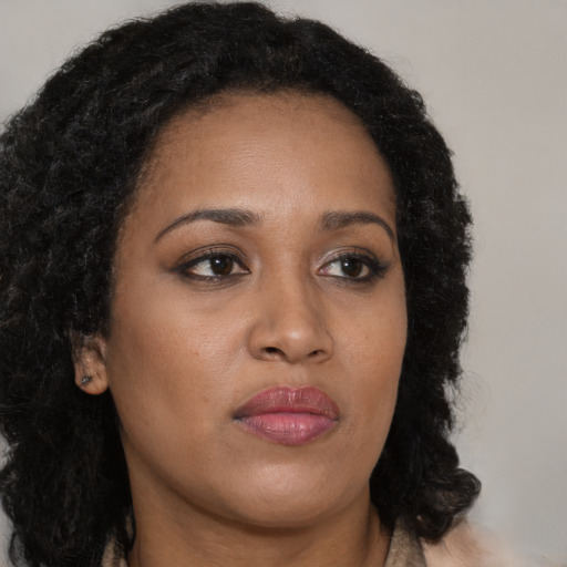 Neutral black young-adult female with long  brown hair and brown eyes
