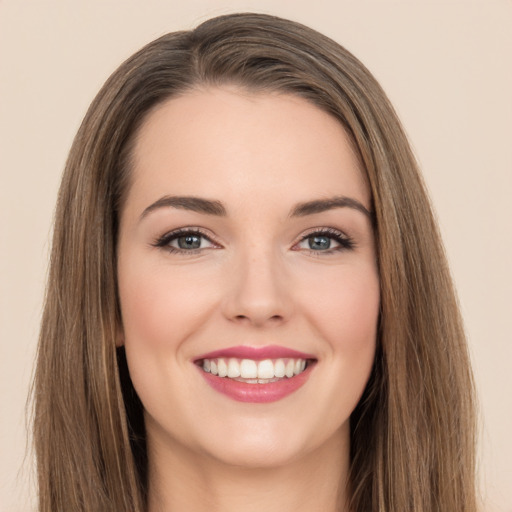 Joyful white young-adult female with long  brown hair and brown eyes