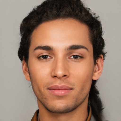 Joyful latino young-adult male with short  brown hair and brown eyes