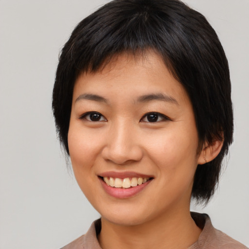 Joyful asian young-adult female with medium  brown hair and brown eyes