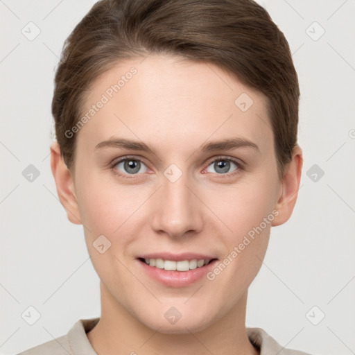 Joyful white young-adult female with short  brown hair and grey eyes