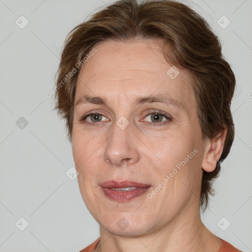 Joyful white adult female with medium  brown hair and brown eyes