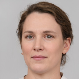 Joyful white adult female with medium  brown hair and grey eyes