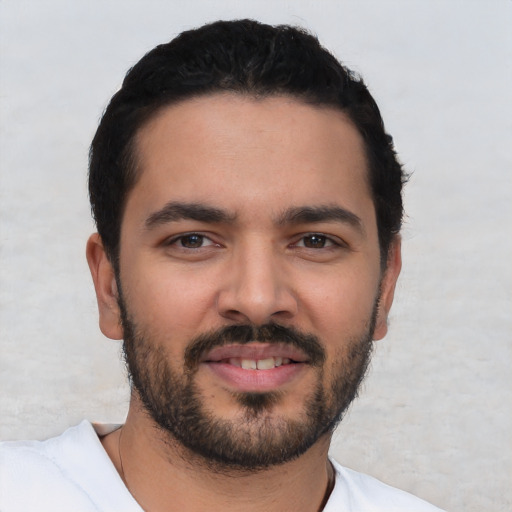 Joyful latino young-adult male with short  black hair and brown eyes