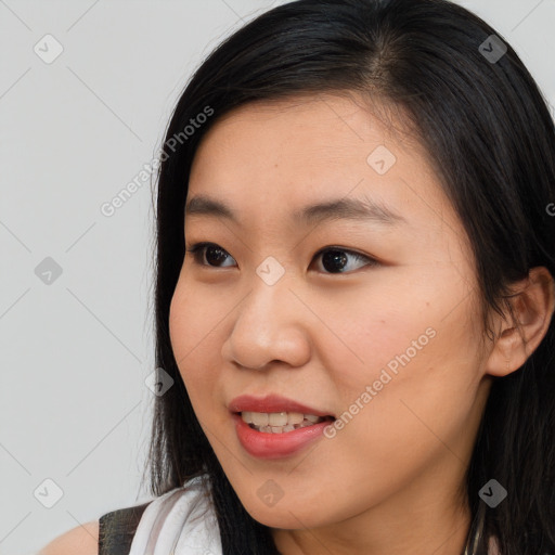 Joyful asian young-adult female with long  brown hair and brown eyes