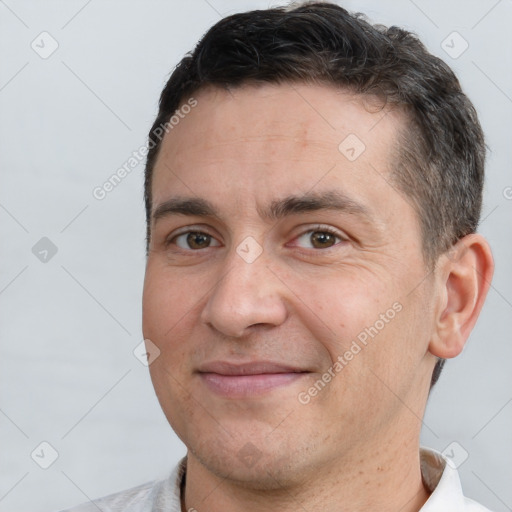 Joyful white adult male with short  brown hair and brown eyes