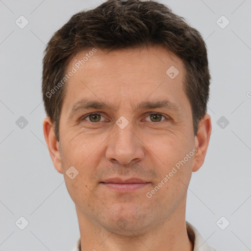 Joyful white adult male with short  brown hair and brown eyes