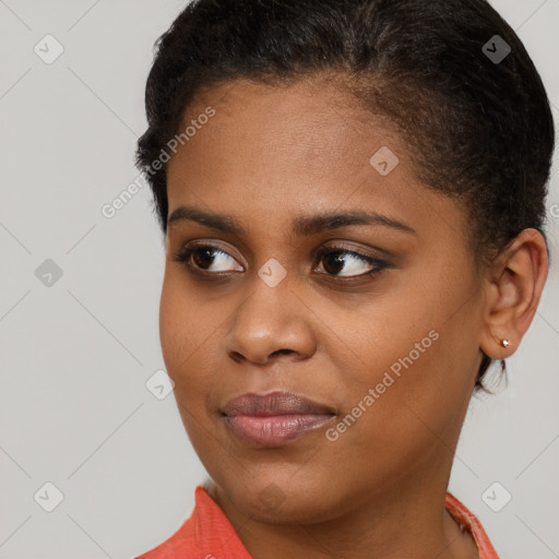 Joyful black young-adult female with short  brown hair and brown eyes