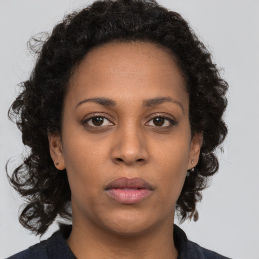 Neutral black young-adult female with medium  brown hair and brown eyes