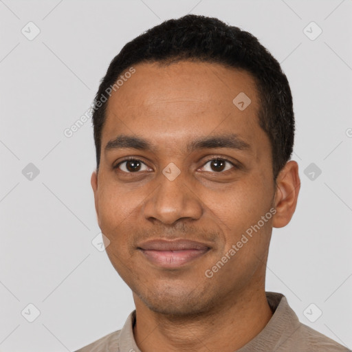 Joyful black young-adult male with short  black hair and brown eyes