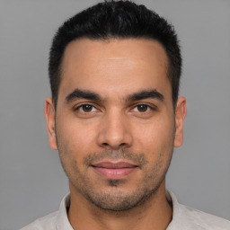 Joyful white young-adult male with short  black hair and brown eyes