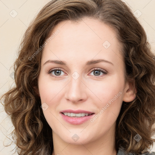 Joyful white young-adult female with long  brown hair and green eyes