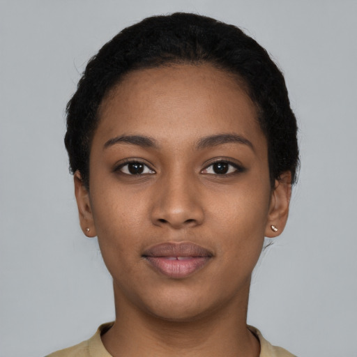 Joyful black young-adult female with short  black hair and brown eyes