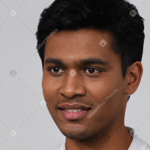 Joyful black young-adult male with short  black hair and brown eyes