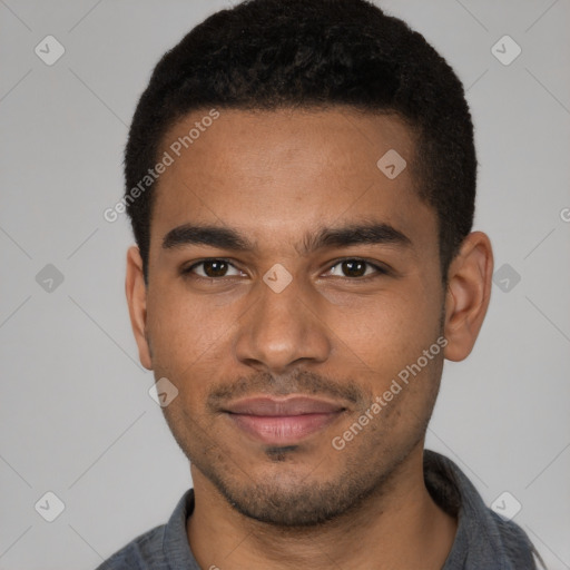 Joyful black young-adult male with short  black hair and brown eyes