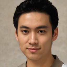 Joyful asian young-adult male with short  black hair and brown eyes