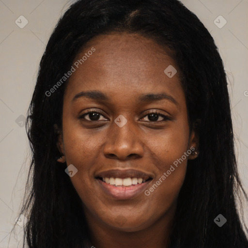 Joyful black young-adult female with long  black hair and brown eyes