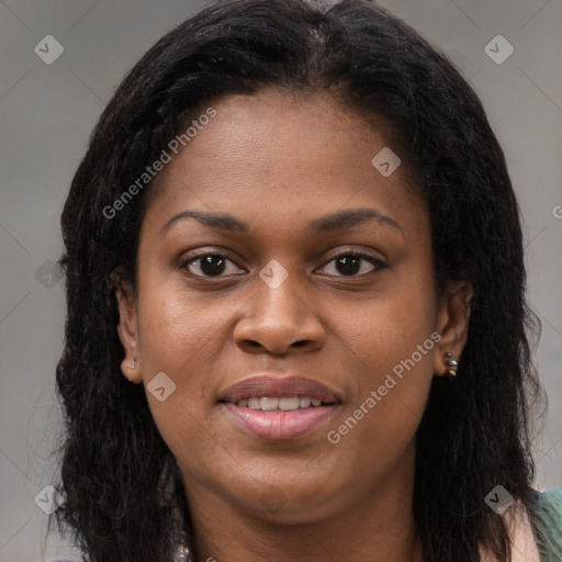 Joyful black young-adult female with long  brown hair and brown eyes