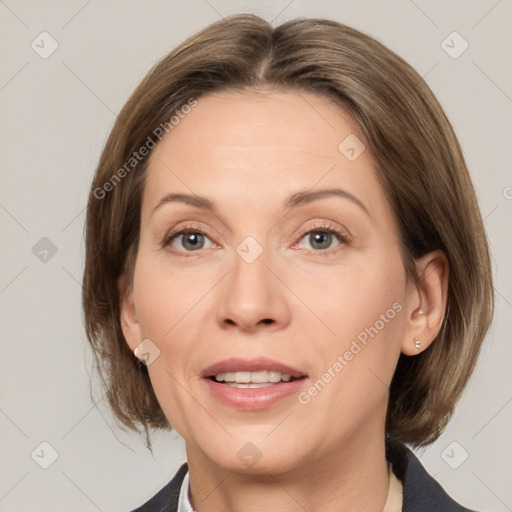 Joyful white adult female with medium  brown hair and grey eyes