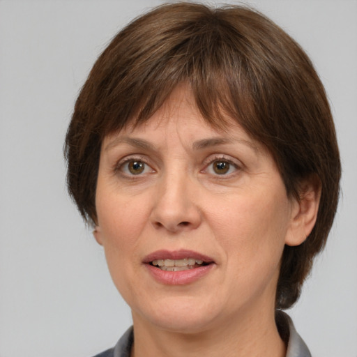 Joyful white adult female with medium  brown hair and grey eyes