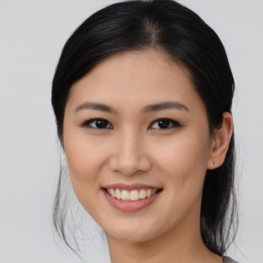 Joyful asian young-adult female with medium  brown hair and brown eyes