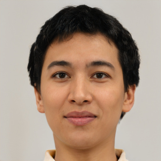 Joyful latino young-adult male with short  black hair and brown eyes