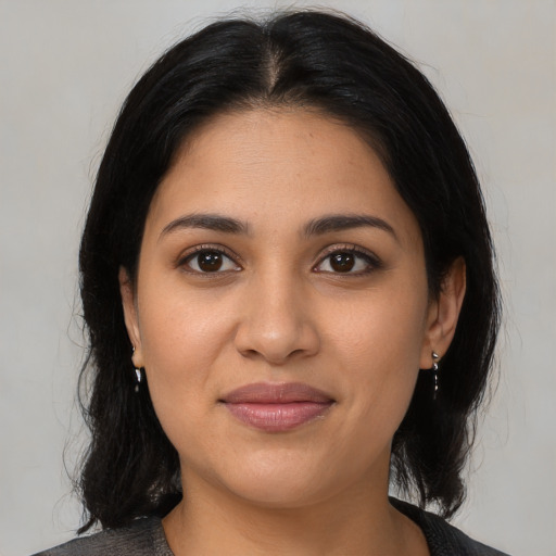 Joyful latino young-adult female with medium  black hair and brown eyes