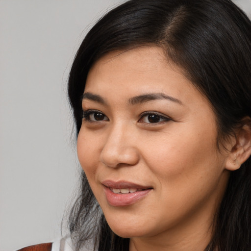 Joyful latino young-adult female with medium  black hair and brown eyes