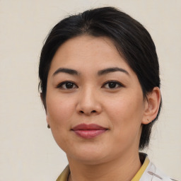 Joyful asian young-adult female with medium  brown hair and brown eyes