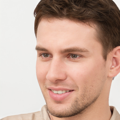 Joyful white young-adult male with short  brown hair and grey eyes