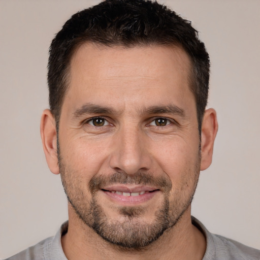 Joyful white adult male with short  brown hair and brown eyes