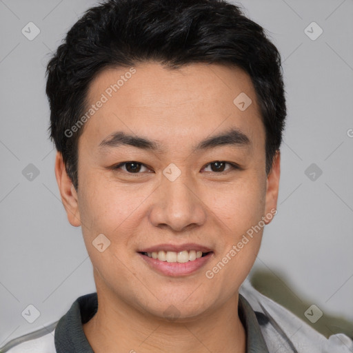 Joyful asian young-adult male with short  black hair and brown eyes